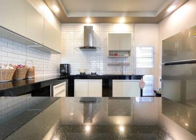 Modern kitchen with stainless steel appliances and black countertops