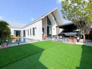 Modern house exterior with lush garden and outdoor patio