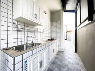 Modern kitchen with white cabinetry and stainless steel sink