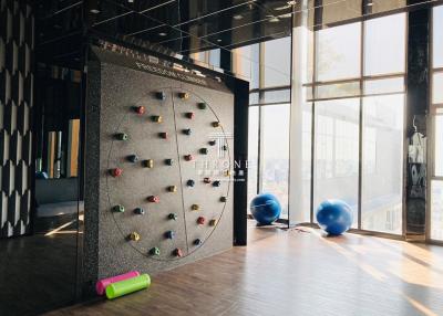 Indoor fitness area with climbing wall and exercise equipment
