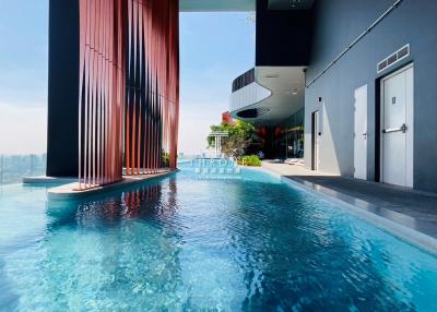 Luxurious outdoor swimming pool with city view at modern residential building