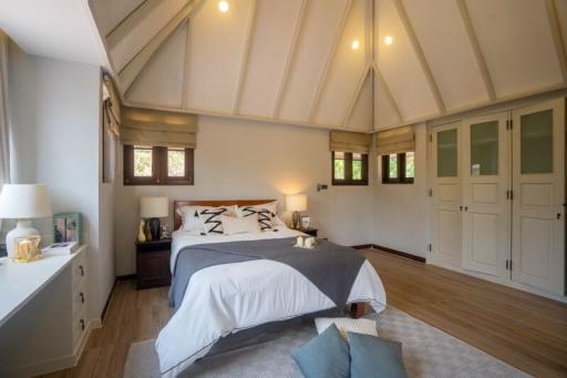 Spacious and bright attic bedroom with large bed and high ceilings