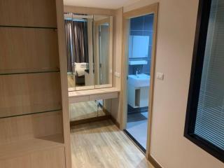 Modern bedroom with en-suite bathroom and wooden flooring