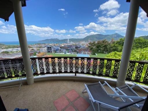 Spacious balcony with a beautiful sea and city view under a clear blue sky