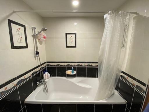 Modern bathroom with bathtub and monochrome tile design