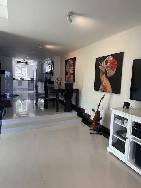 Modern living room with dining area and glossy floor tiles