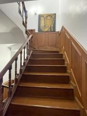 Wooden staircase with a painting on the wall