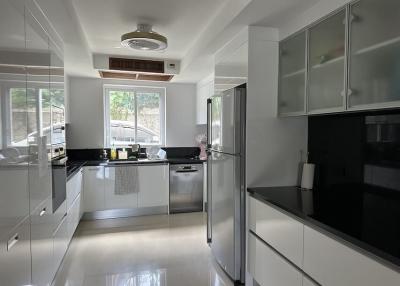 Modern kitchen with white cabinetry and stainless steel appliances