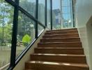 Bright staircase with wooden steps and glass ceiling