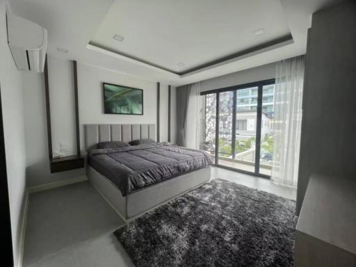 Modern bedroom with a large bed and natural light