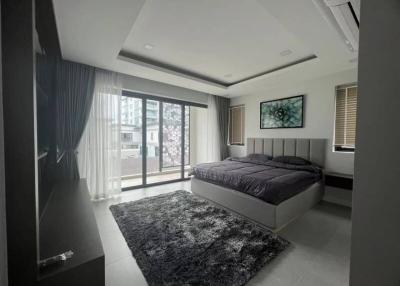 Modern bedroom with large windows and ample lighting