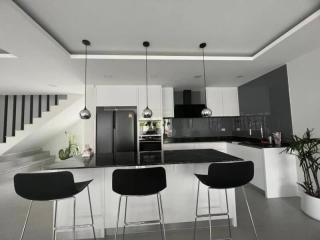 Modern kitchen with black countertops and stainless steel appliances