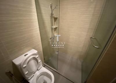 Modern bathroom with a glass shower enclosure and a white toilet
