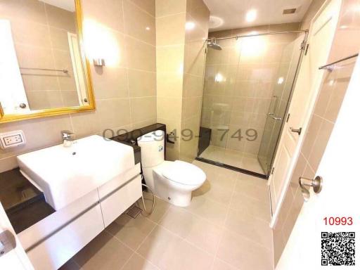 Modern bathroom with glass shower enclosure and vanity