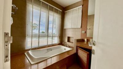 Spacious bathroom with large window and bathtub