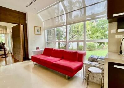 Bright and modern living room with red sofa and floor-to-ceiling windows