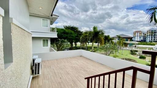 Spacious balcony with a view of the surrounding landscape and partial view of the building exterior