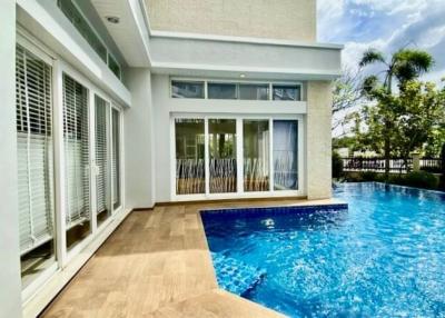 Contemporary house exterior with swimming pool and patio area