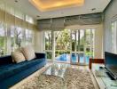 Spacious living room with ample natural light, overlooking the pool