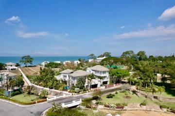 Aerial view of coastal residential area with houses and landscaping