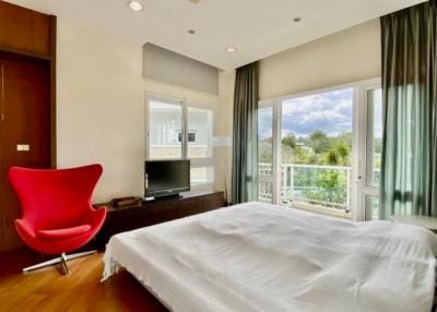 Bright bedroom with modern furniture and balcony view