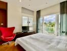 Bright bedroom with modern furniture and balcony view