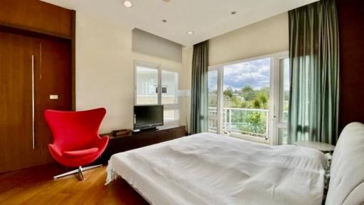 Bright bedroom with modern furniture and balcony view