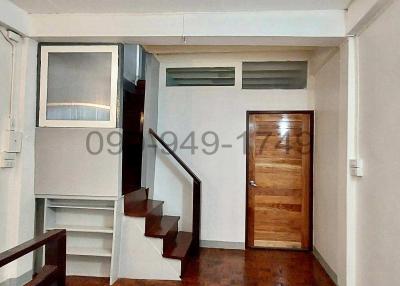 Compact interior space with staircase and air conditioning unit