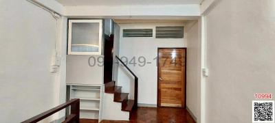 Compact interior space with staircase and air conditioning unit