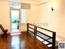 Spacious well-lit living area with parquet flooring and a glass door leading to the exterior