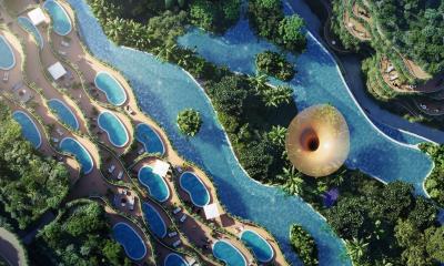 Aerial view of a luxurious resort with multiple swimming pools and lush greenery