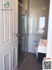 Modern bathroom interior with glass door shower and city view