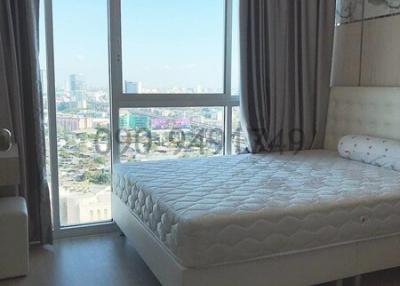 Bright and airy bedroom with large window and city view
