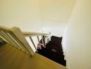 White wooden railing on the staircase inside a property