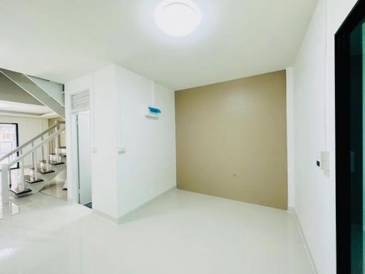 Bright and clean hallway with stairs and tiled flooring in a modern home