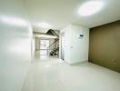 Bright and spacious hallway with staircase and tiled flooring