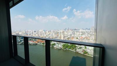 Panoramic city view from a high-rise balcony overlooking a river