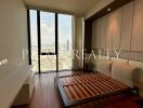 Modern bedroom with floor-to-ceiling windows and city view