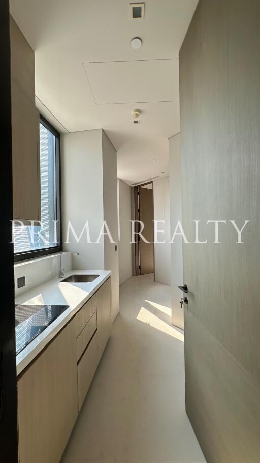 Modern compact kitchen with ample cabinetry and natural light