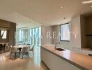 Modern kitchen with dining area and large windows