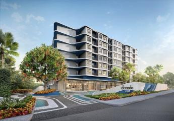 Modern residential building exterior at dusk with illuminated windows and landscaped entrance