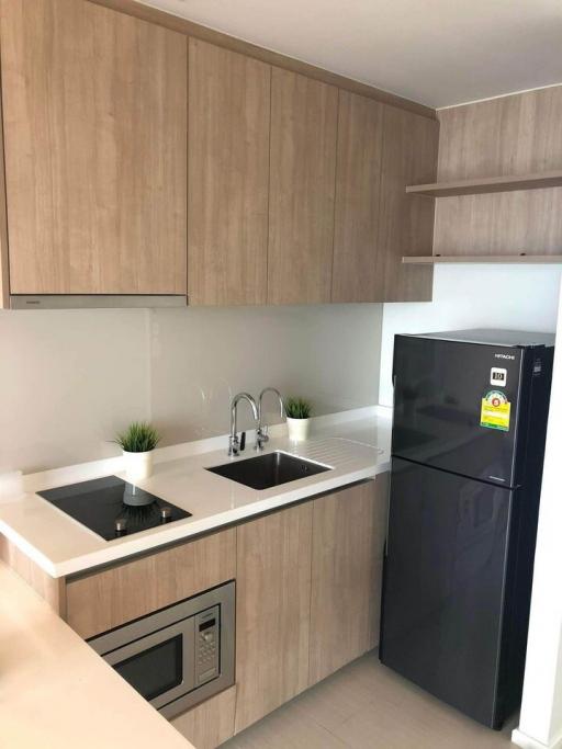 Modern kitchen with wooden cabinets and stainless steel appliances