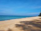 Serene beachfront view with clear blue skies