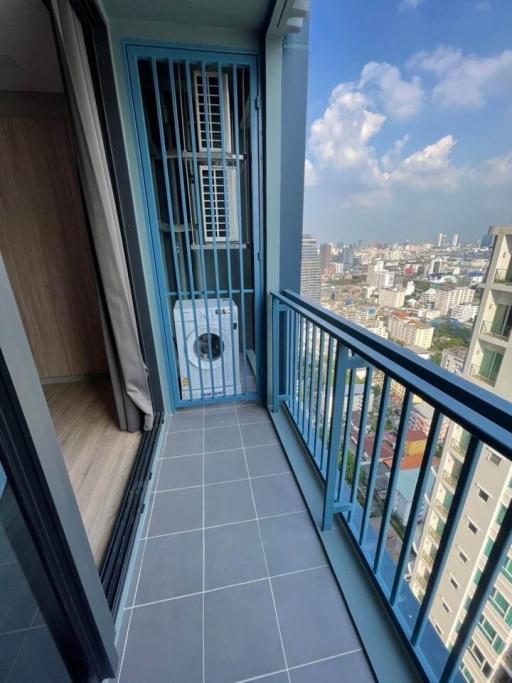 Compact balcony with city view and floor-to-ceiling window