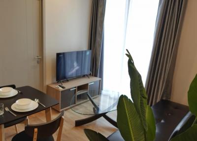 Modern living room with dining table and flat-screen TV