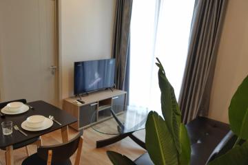 Modern living room with dining table and flat-screen TV