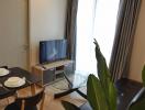 Modern living room with dining table and flat-screen TV