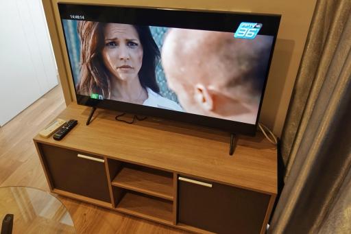 Modern television on a wooden tv stand in a living room