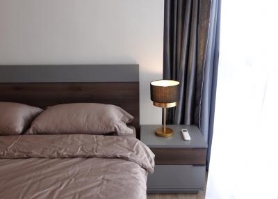 Cozy bedroom with comfortable bedding and modern lamp on bedside table