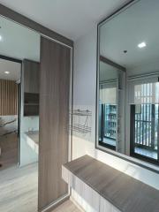 Compact bedroom with built-in wardrobe and large window